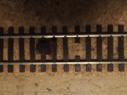 The sleeper is cut away between the rails